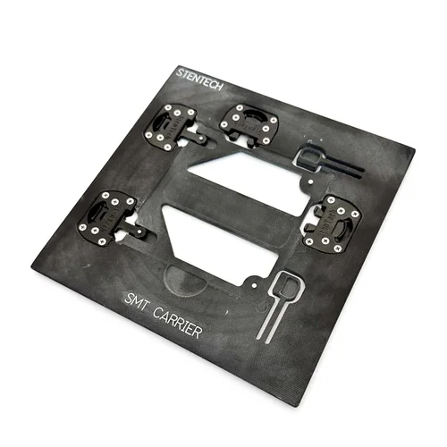 Square black composite SMT carrier plate, shown flat on a white surface, with central cutouts and four black rotating holddown clamps