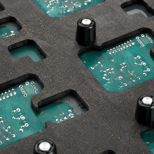 Close-up of CNC-machined wave pockets and solder channels on wave solder pallet